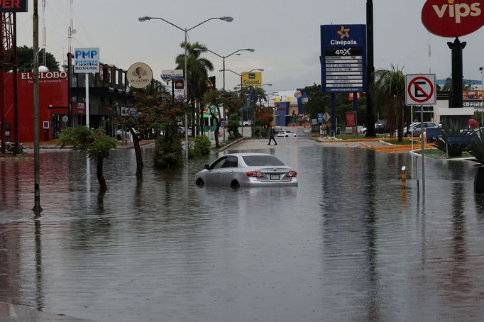 A car is seen in a flooded street following heavy rains, in Merida, Mexico, June 24, 2024. REUTERS/Lorenzo Hernandez