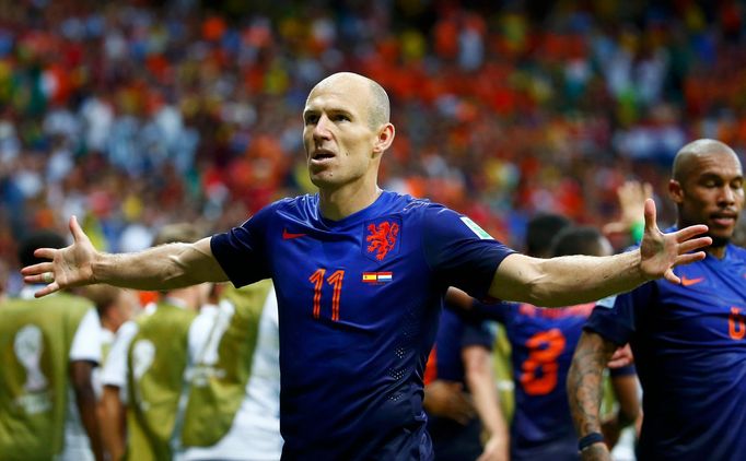 Arjen Robben of the Netherlands gestures as he celebrates after scoring a goal against Spain during their 2014 World Cup Group B soccer match at the Fonte Nova arena in S