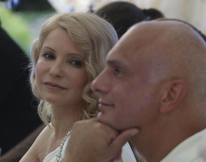 Ukrainian former Prime Minister Yulia Tymoshenko (L) looks at her husband Oleksander on his birthday in Kiev in this June 2010 handout photo. Poland said on Thursday Ukraine's reputation would "suffer dramatically" if no humanitarian solution for the case of jailed ex-premier Yulia Tymoshenko were found, but criticised calls for a boycott of the pending European soccer tournament in Ukraine. REUTERS/Alexander Prokopenko/Yulia Tymoshenko Press Service/Handout (UKRAINE - Tags: POLITICS CRIME LAW) FOR EDITORIAL USE ONLY. NOT FOR SALE FOR MARKETING OR ADVERTISING CAMPAIGNS. THIS IMAGE HAS BEEN SUPPLIED BY A THIRD PARTY. IT IS DISTRIBUTED, EXACTLY AS RECEIVED BY REUTERS, AS A SERVICE TO CLIENTS