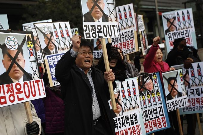 Activists from anti-North Korea civic group chant slogans during a rally against North Korea's nuclear test near the U.S. embassy in central Seoul February 12, 2013. North Korea conducted its third nuclear test on Tuesday in defiance of U.N. resolutions, angering the United States and Japan and prompting its only major ally, China, to call for calm. The placard (top C) reads, "Kim Jong-un out!" REUTERS/Kim Hong-Ji (SOUTH KOREA - Tags: CIVIL UNREST POLITICS) Published: Úno. 12, 2013, 9:10 dop.