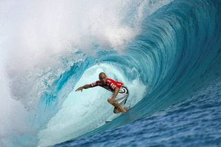 FILE PHOTO: Surfing great Kelly Slater of the U.S rides a wave during the third round of competition in the Billabong Pro surfing tournament on the legendary reef break i