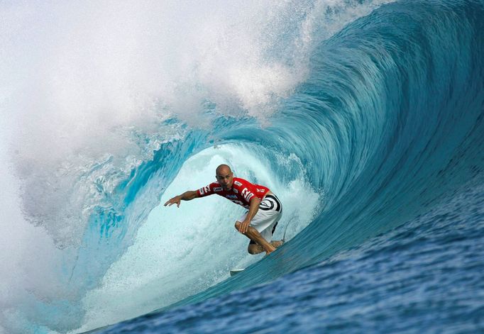 FILE PHOTO: Surfing great Kelly Slater of the U.S rides a wave during the third round of competition in the Billabong Pro surfing tournament on the legendary reef break i