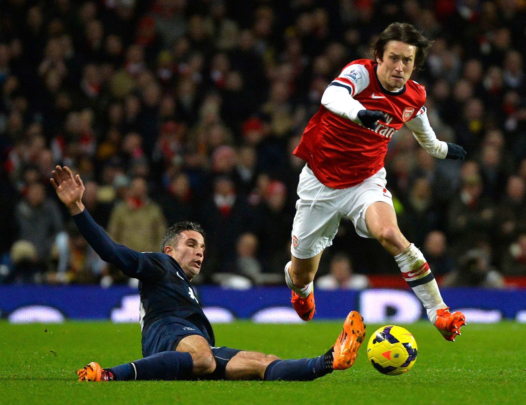 Arsenal's Rosicky challenges Manchester United's Van Persie during their English Premier League soccer match at the Emirates stadium in London