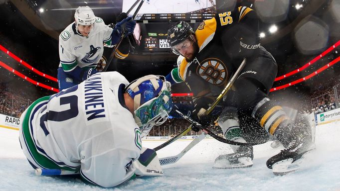 Nov 26, 2024; Boston, Massachusetts, USA; Boston Bruins right wing Justin Brazeau (55) can’t get to a loose puck before Vancouver Canucks goaltender Kevin Lankinen (32) c