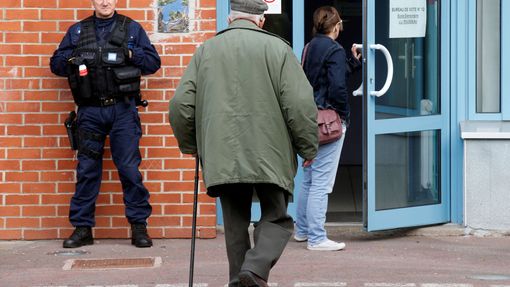 Policista hlídá volební místnost v městečku Henin-Beaumont na severu Francie.