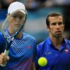 Czech Stepanek and Berdych walk to their positions before serving to Argentina's Berlocq and Zeballos during their Davis Cup semi-final doubles match in Prague