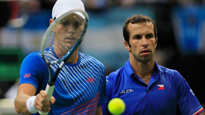 Radek Stepanek (R) and Tomas Berdych of the Czech Republic walk to their positions before serving to Argentina's Carlos Berlocq and Horacio Zeballos during their Davis Cu