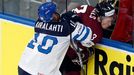 Latvia's Juris Stals (R) is pinned to the boards by Finland's Jere Karalahti (L) during the second period of their men's ice hockey World Championship group B game at Min