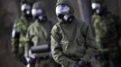 Brazilian army soldiers wearing chemical suits participate in an anti-terror simulation exercise as part of the preparation for the upcoming 2013 FIFA Confederations Cup in Brasilia. May 22, 2013. About 100 soldiers took part in the exercise which include preventive strikes against chemical, biological and radiological weapons conducted around Mane Garrincha National Stadium, according to an official statement. REUTERS/Ueslei Marcelino (BRAZIL - Tags: SPORT SOCCER MILITARY) Published: Kvě. 22, 2013, 9:43 odp.