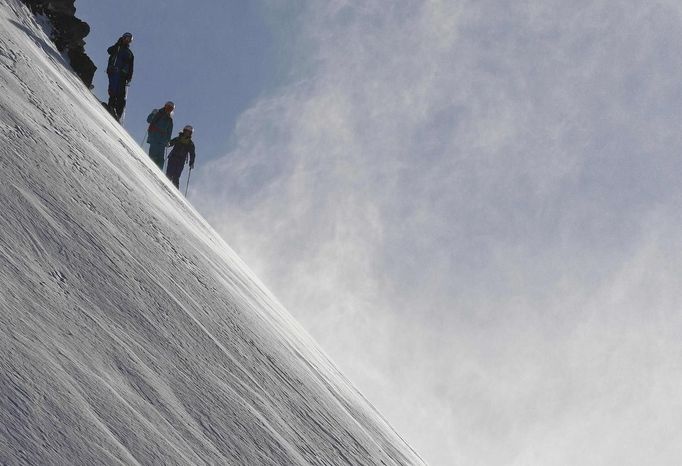 Austrian freeride skier Lukas Ebenbichler, Karin Huttary and Christiane Bauer (L-R) wait on top of a deep powder snow slope during a freeride skiing tour on Stubaier glacier mountain in Stubai January 7, 2013. Backcountry or freeride skiers ski away from marked slopes with no set course or goals, in untamed snow, generally in remote mountainous areas. Picture taken January 7, 2013. REUTERS/ Dominic Ebenbichler (AUSTRIA - Tags: SPORT SKIING) Published: Led. 21, 2013, 10:19 dop.