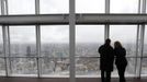 Two visitors take in the panorama from the viewing platform at the Shard which opened to the public today, in London