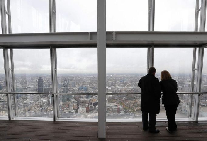 Two visitors take in the panorama from the viewing platform at the Shard which opened to the public today, in London