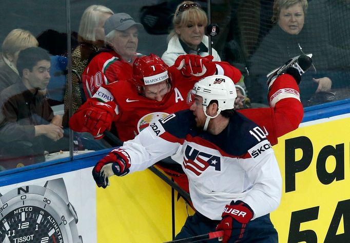 Jimmy Hayes of the U.S. (R) blocks Vladimir Denisov of Belarus (L) during the first period of their men's ice hockey World Championship Group B game at Minsk Arena in Min