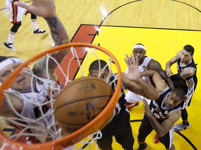 Miami Heat small forward LeBron James (6) is blocked out by San Antonio Spurs' Gary Neal (14) and Danny Green (R) as Chris Andersen (L) scores on Tim Duncan (21) during G