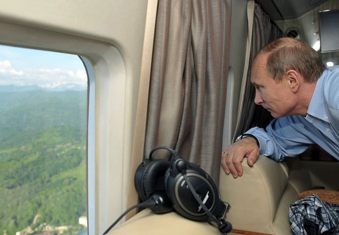 Russian president and British Prime minister meet in Sochi SOCHI, RUSSIA. MAY 10, 2013. President of Russia Vladimir Putin looks through a helicopter window as he is flying over the Sochi Olympic Park along the Black Sea coast in the Imeretinskaya Valley.