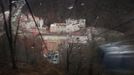 A picture taken through the tinted window of a moving gondola shows the winter sport resort of Rosa Khutor, a venue for the Sochi 2014 Winter Olympics near Sochi February 19, 2013. Although many complexes and venues in the Black Sea resort of Sochi mostly resemble building sites that are still under construction, there is nothing to suggest any concern over readiness. Construction will be completed by August 2013 according to organizers. The Sochi 2014 Winter Olympics opens on February 7, 2014. REUTERS/Kai Pfaffenbach (RUSSIA - Tags: BUSINESS CONSTRUCTION CITYSCAPE ENVIRONMENT SPORT OLYMPICS TPX IMAGES OF THE DAY) Published: Úno. 19, 2013, 12:38 odp.