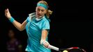 Petra Kvitova of the Czech Republic hits a return to Maria Sharapova of Russia during their WTA Finals singles tennis match at the Singapore Indoor Stadium October 23, 20