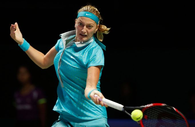 Petra Kvitova of the Czech Republic hits a return to Maria Sharapova of Russia during their WTA Finals singles tennis match at the Singapore Indoor Stadium October 23, 20