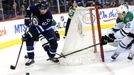 Mar 16, 2014; Winnipeg, Manitoba, CAN; Winnipeg Jets forward Michael Frolik (67) controls the puck behind the Dallas net as Dallas Stars forward Colton Sceviour (22) chal