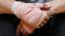 The hands of unemployed Belgian Mohamed Sammar are seen during a "Fit for a job" boxing class in Brussels July 1, 2013. Sammar, 27, has been looking for a job in the construction sector for 2 years. "Fit for a job" is the initiative of former Belgian boxing champion Bea Diallo, whose goal was to restore the confidence of unemployed people and help them find a job through their participation in sports. Picture taken July 1, 2013. REUTERS/Francois Lenoir (BELGIUM - Tags: SPORT BOXING SOCIETY TPX IMAGES OF THE DAY BUSINESS EMPLOYMENT) Published: Čec. 5, 2013, 4:14 odp.