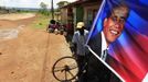 Paul Opiyo Ojwang, 43, repairs a bicycle at his open-air garage in Kogelo village, the ancestral home of U.S. President Barack Obama (pictured in poster), at Nyangoma Kogelo shopping centre, 430 km (367 miles) west of Kenya's capital Nairobi, November 5, 2012. Four years ago, Kogelo, and Africa in general, celebrated with noisy gusto when Obama, whose father came from the scattered hamlet of tin-roofed homes, became the first African-American to be elected president of the United States. Looking across the Atlantic to the Nov. 6 presidential election, the continent is cooler now towards the "son of Africa" who is seeking a second term. There are questions too whether his Republican rival, Mitt Romney, will have more to offer to sub-Saharan Africa if he wins the White House. To match Analysis AFRICA-USA/ELECTION REUTERS/Thomas Mukoya (KENYA - Tags: SOCIETY ELECTIONS POLITICS) Published: Lis. 5, 2012, 11:31 dop.