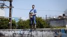 Thanos Kehagias holds his mother's dog Vagos as he poses for a picture outside his student flat in the Greek city of Patra