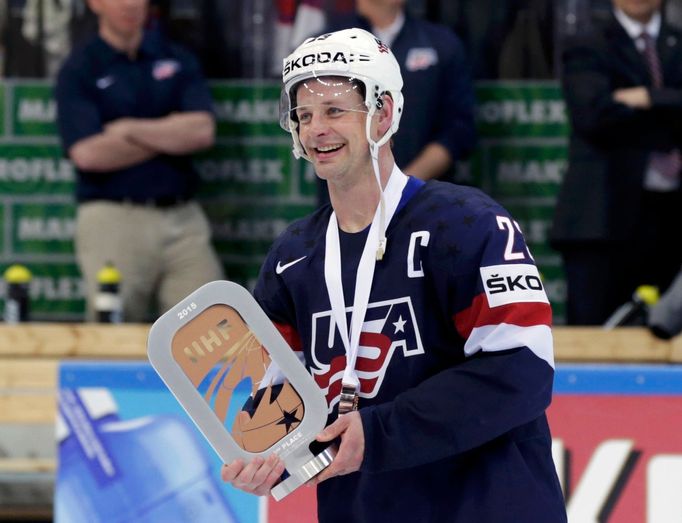 Matt Hendricks of the U.S.holds the third place trophy after their Ice Hockey World Championship third-place game against the Czech Republic at the O2 arena in Prague, Cz