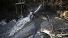 An illegal miner or garimpeiro digs with a pressure hose in the southern state of Bolivar November 15, 2012. In the triangle that connects Venezuela, Brazil and Guyana a huge number of illegal gold and diamonds prospectors or garimpeiros dream of changing their lives overnight by finding a huge bonanza. Picture taken November 15, 2012. REUTERS/Jorge Silva (VENEZUELA - Tags: BUSINESS EMPLOYMENT SOCIETY) ATTENTION EDITORS: PICTURE 5 OF 20 FOR PACKAGE 'DIAMONDS IN THE JUNGLE'. TO FIND ALL IMAGES SEARCH 'DIAMONDS PROSPECTORS' Published: Pro. 3, 2012, 10:01 dop.