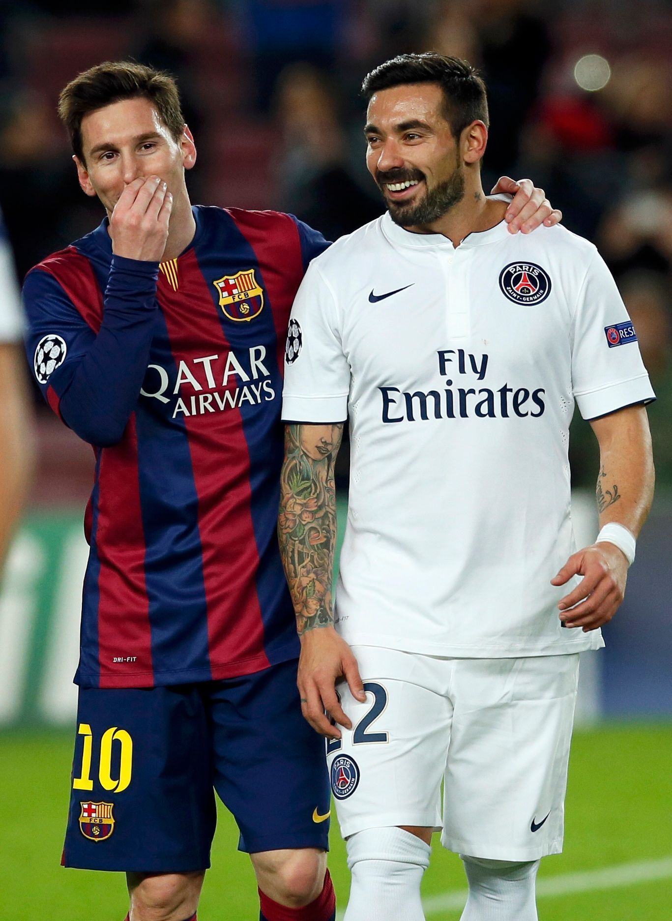 Paris St Germain's Ezequiel Lavezzi walks off the pitch with his compatriot Barcelona's Lionel Messi at the end of their Champions League Group F soccer match at the Nou Camp stadium in Barcelona
