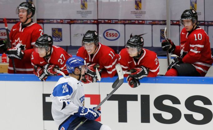 Finland's Teravainen celebrates in front of Canada's bench after scoring on a penalty s