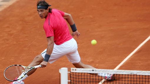 Španělský tenista Rafael Nadal stihl míček v utkání proti Argentinci Juanu Monacovi během osmifinále French Open 2012.
