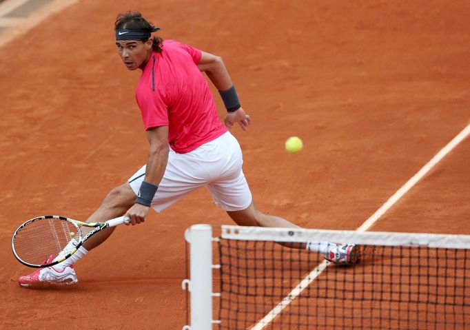 Španělský tenista Rafael Nadal stihl míček v utkání proti Argentinci Juanu Monacovi během osmifinále French Open 2012.