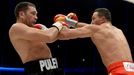 Ukrainian WBA, WBO, IBO and IBF heavyweight boxing world champion Vladimir Klitschko (R) delivers a punch to his challenger Bulgarian Kubrat Pulev during their title figh