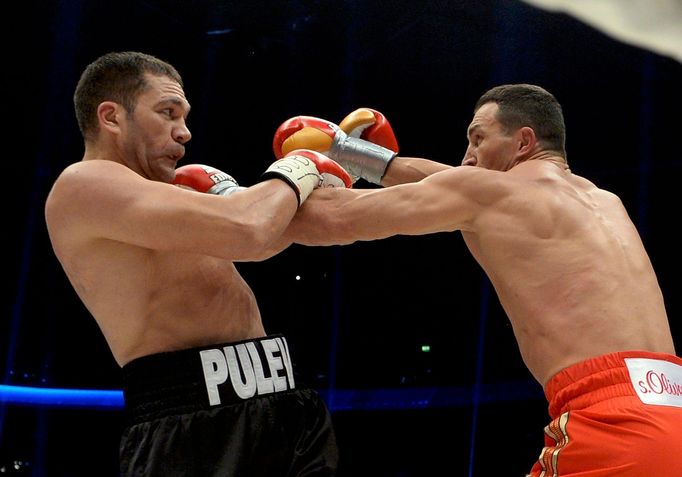 Ukrainian WBA, WBO, IBO and IBF heavyweight boxing world champion Vladimir Klitschko (R) delivers a punch to his challenger Bulgarian Kubrat Pulev during their title figh