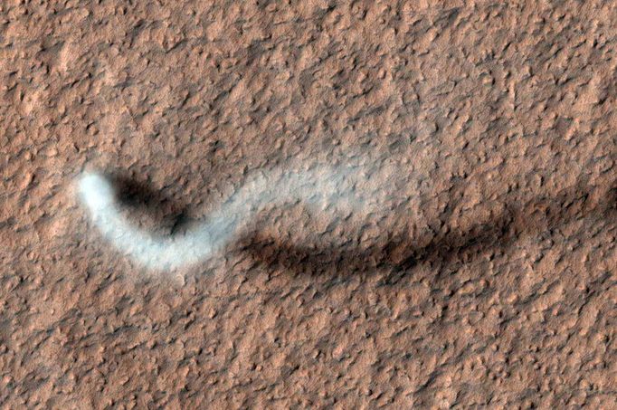 Mars’ Whirling Dust Devil A Martian dust devil roughly 12 miles (20 kilometers) high was captured winding its way along the Amazonis Planitia region of Northern Mars on March 14, 2012 by the High Resolution Imaging Science Experiment (HiRISE) camera on NASA's Mars Reconnaissance Orbiter. Despite its height, the plume is little more than three-quarters of a football field wide (70 yards, or 70 meters). HiRISE is operated by the University of Arizona, Tucson. The instrument was built by Ball Aerospace & Technologies Corp., Boulder, Colo. The Mars Reconnaissance Orbiter Project and the Mars Exploration Rover Project are managed by the Jet Propulsion Laboratory, Pasadena, Calif., for NASA's Science Mission Directorate, Washington. JPL is a division of the California Institute of Technology, also in Pasadena. Lockheed Martin Space Systems, Denver, built the orbiter. For more about the Mars Reconnaissance Orbiter, see: http://www.nasa.gov/mro Image credit: NASA/JPL-Caltech/UA