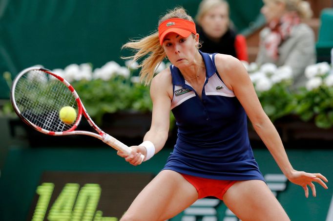 Alize Cornet of France returns a forehand to Taylor Townsend of the U.S. during their women's singles match at the French Open tennis tournament at the Roland Garros stad