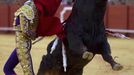 Mexican matador Diego Silveti performs a back-pass to a bull during a bullfight in Seville