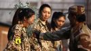 RNPS IMAGES OF THE YEAR 2012 - An instructor from the Tianjiao Special Guard/Security Consultant Ltd. Co, smashes a bottle over a female recruit's head during a training session for China's first female bodyguards in Beijing January 13, 2012. According to the company, the training session consists of 20 women, mostly college graduates, who will undergo 8-10 months of training to develop sufficient skills to become security guards. The company will then offer the best trainee a chance to attend the International Security Academy in Israel. REUTERS/David Gray (CHINA - Tags: SOCIETY TPX IMAGES OF THE DAY) Published: Pro. 3, 2012, 1:02 dop.