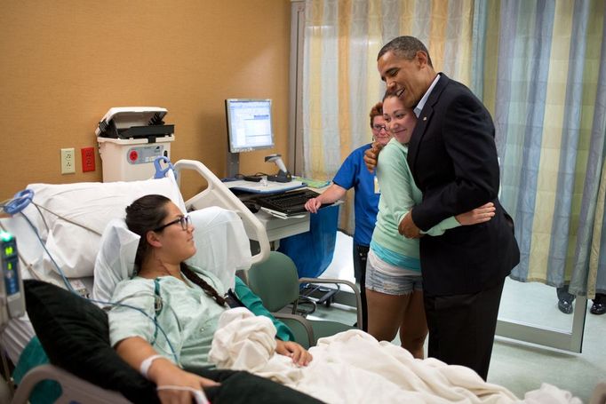 July 22, 2012 "The President hugs Stephanie Davies, who helped keep her friend, Allie Young, left, stay alive after she was shot during the movie theater shootings in Aurora, Colo. The President visited patients and family members affected by the shootings at the University of Colorado Hospital. The President later told their story in a news conference."