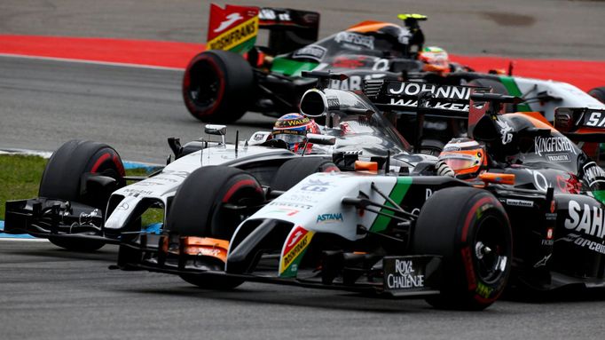 Force India Formula One driver Nico Hulkenberg of Germany (R) and McLaren Formula One driver Jenson Button of Britain (L) drive through a corner during the German F1 Gran