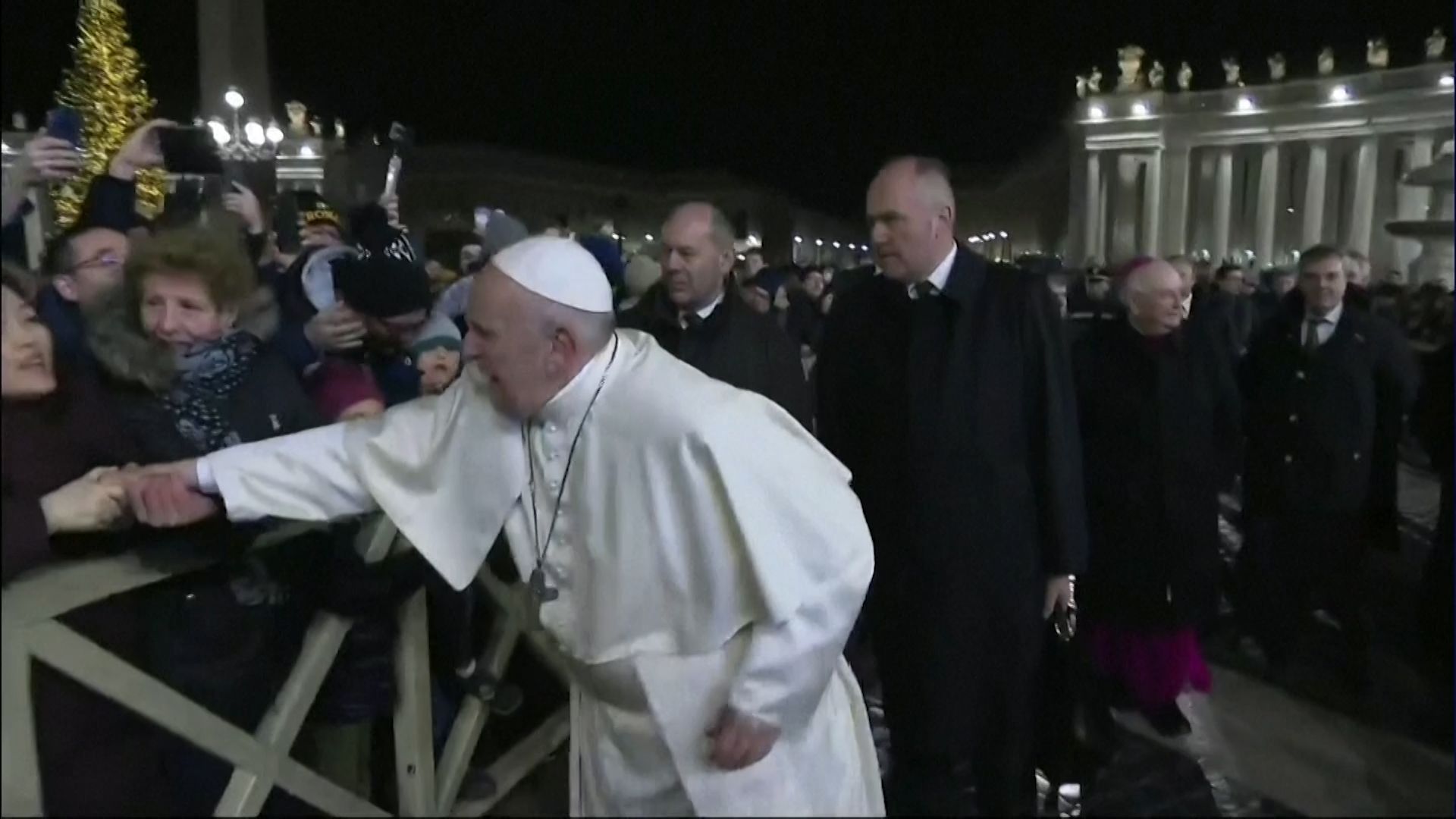 Papež se snaží vyprostit z náhlého sevření ruky