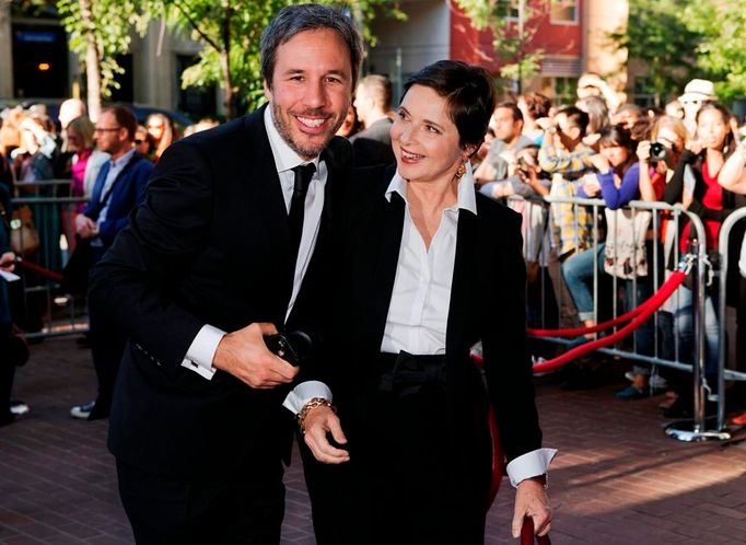 Denis Villeneuve arrives with actress Isabella Rossellini for the "Enemy