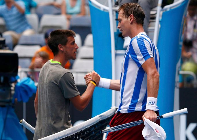 Tomas Berdych of Czech Republic shakes hands with Damir Dzumhur of Bosnia and Herzegovina after their men's singles match at the Australian Open 2014 tennis tournament in