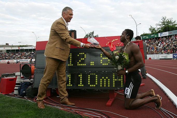 Dayron Robles před světelnou tabulí se svým světovým rekordem na 110 metrů překážek v Ostravě přebírá cenu od premiéra Mirka Topolánka.