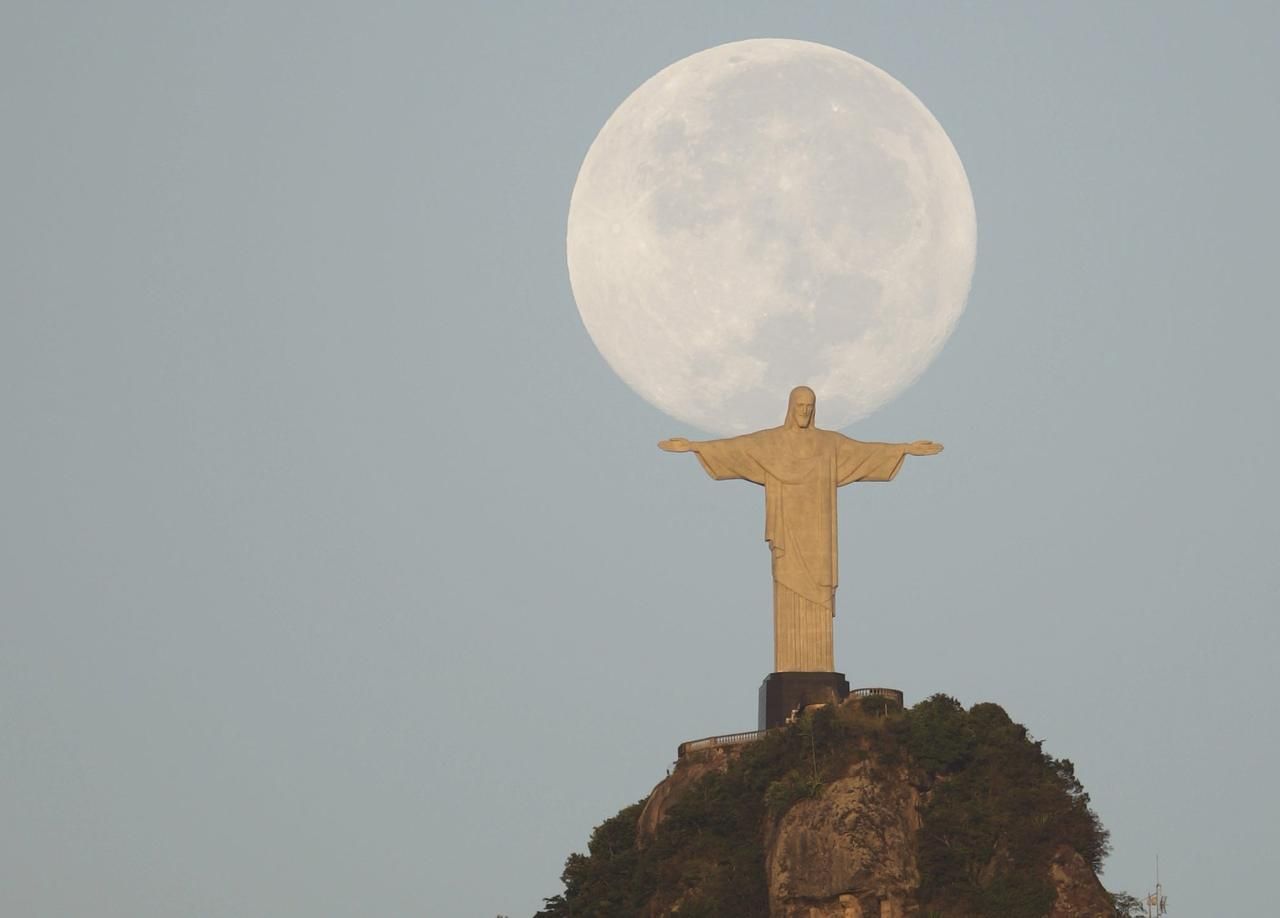 Úplněk a socha Krista Spasitele (Vykupitele) na kopci Corcovado, který se tyčí nad brazilským městem Rio de Janeiro.