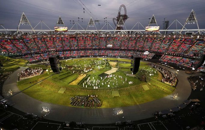 Spectators watch a pre-show in the Olympic Stadium before the opening ceremony of the London 2012 Olympic Games