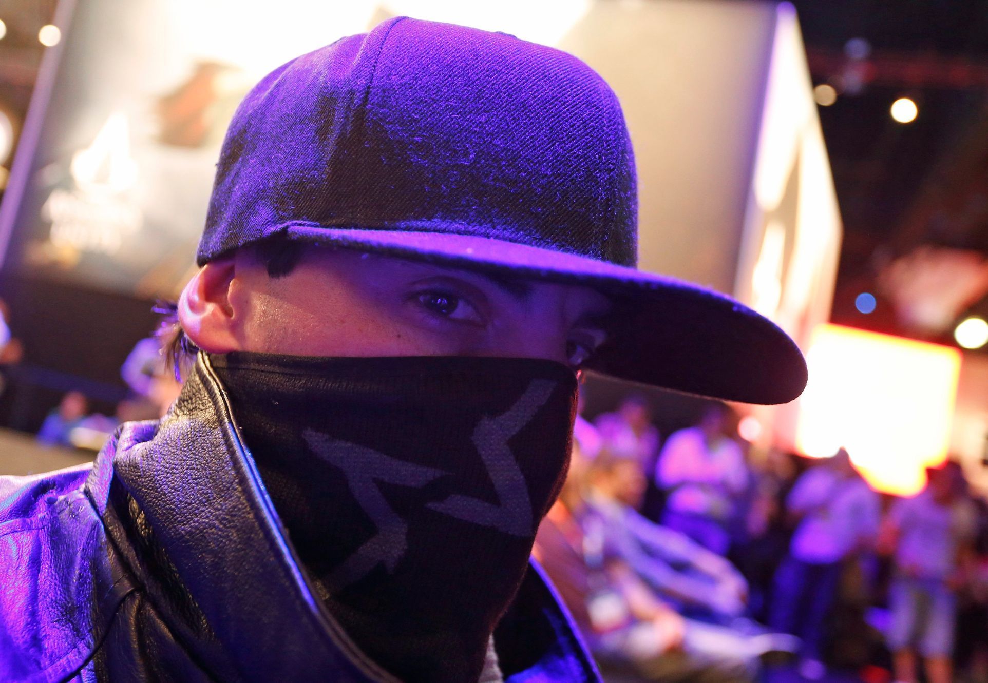 A man dressed as a character from the video game &quot;Watch Dogs&quot; poses at the Ubisoft booth during the 2014 Electronic Entertainment Expo, known as E3, in Los Angeles