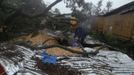 Residents retrieve their belongings after their house was destroyed by a fallen tree caused by Typhoon Bopha in Cagayan de Oro City, southern Philippines December 4, 2012. At least 34 people, mostly soldiers, were killed after flash flood struck a military temporary command post in New Bataan, Compostela Valley, local media reported. REUTERS/Stringer (PHILIPPINES - Tags: DISASTER ENVIRONMENT SOCIETY) Published: Pro. 4, 2012, 12:49 odp.