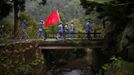 Mid-level government officials dressed in red army uniforms walk after their visit to a memorial site during their 5-day training course at the communist party school called China Executive Leadership Academy of Jinggangshan, in Jiangxi province, in this September 21, 2012 file photo. With China's economy slowing and public scrutiny of officials on the rise via social media, the party is likely to endorse deepening its training push when Hu passes the baton to new leaders at the 18th Party Congress, which is expected to be held as early as next month. China's cadre training system is run out of academies across the country, some focusing on practical aspects of 21st century communism such as handling the media and management skills, including role-play scenarios on how to manage a variety of crises from mass protests to train crashes. Picture taken September 21, 2012. REUTERS/Carlos Barria/Files (CHINA - Tags: POLITICS SOCIETY) Published: Zář. 25, 2012, 9 odp.