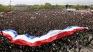 A giant banner in the colours of the French national flag is seen in this general view of tens of thousands of supporters of Francois Hollande, Socialist Party candidate, who attend a campaign rally near the Chateau de Vincennes